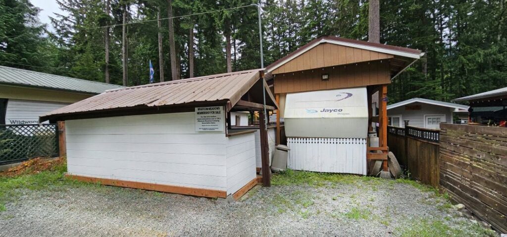 Small wooden buildings surrounded by trees.