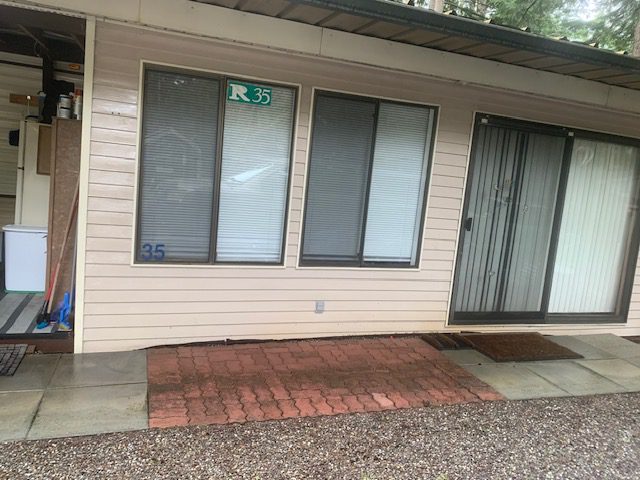 House exterior with windows and sliding door.